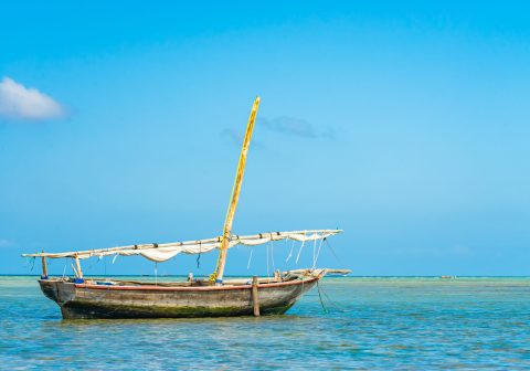 Fishing ship in water of Indian ocean on low tide. Zanzibar, Tanzania Fishing ship in water of Indian ocean on low tide. Zanzibar, Tanzania.